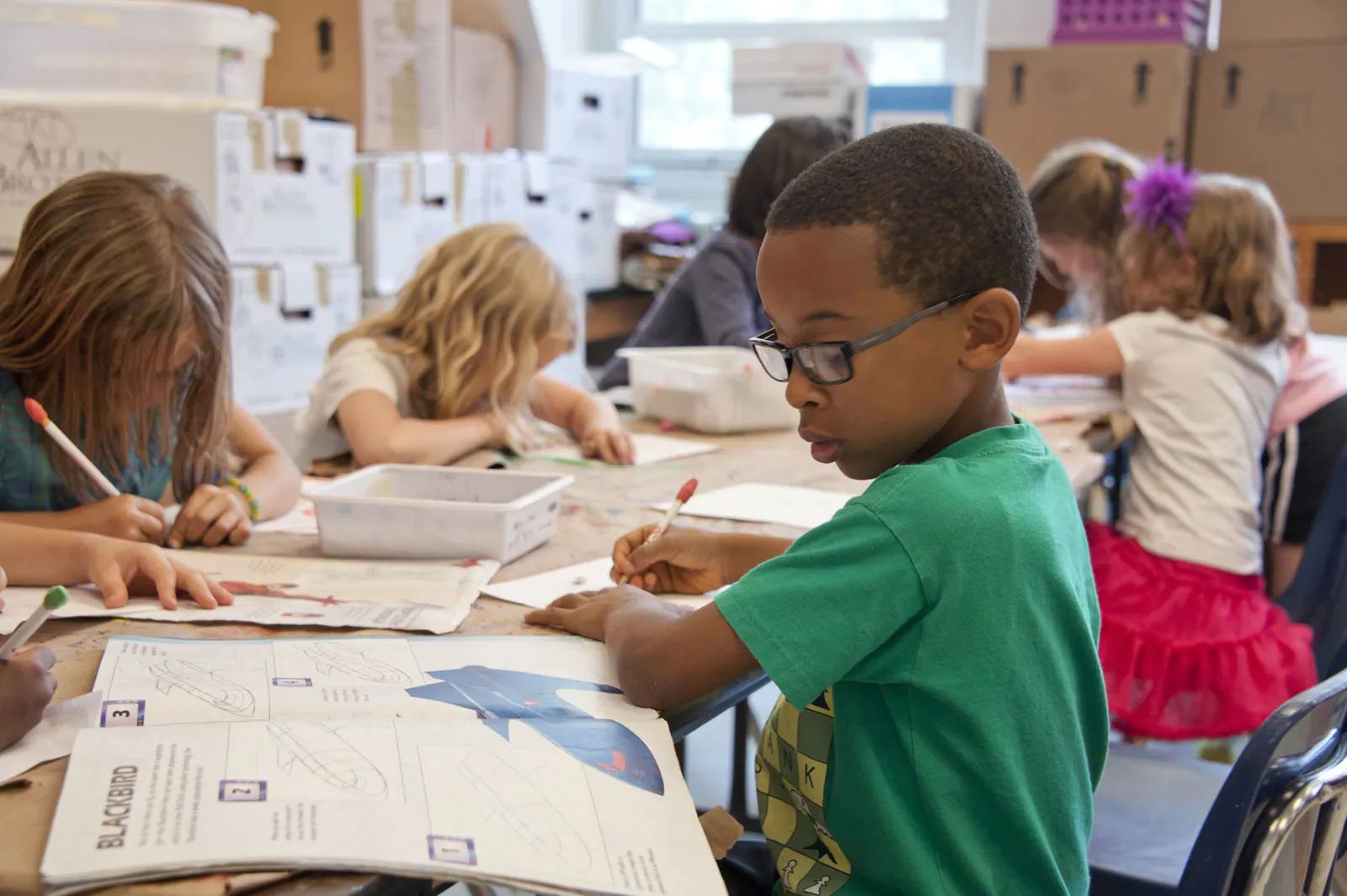 Elementary students working together on a creative classroom activity.